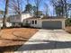 Charming two-story home with attached garage and inviting front yard landscaping at 1336 Candlelite Ln, Snellville, GA 30078