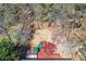 Aerial view of backyard with spacious lawn, wooden deck, mature trees, and lush landscaping at 1564 Pedro Sw Dr, Mableton, GA 30126