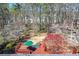 Backyard view features large deck, patio seating, and colorful landscaping, offering space to relax and entertain at 1564 Pedro Sw Dr, Mableton, GA 30126