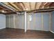 Unfinished basement with dark wood flooring, paneled walls, and open ceiling at 1564 Pedro Sw Dr, Mableton, GA 30126