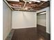 Unfinished basement with dark wood flooring and open ceiling, ready for customization at 1564 Pedro Sw Dr, Mableton, GA 30126