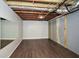 Partially finished basement with laminate flooring, wall mirror, and painted walls at 1564 Pedro Sw Dr, Mableton, GA 30126