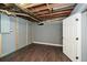 Partially finished basement, showing utility box, paint, and dark laminate flooring at 1564 Pedro Sw Dr, Mableton, GA 30126