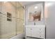 A clean bathroom has a shower/tub combo with a glass door and a bright vanity at 1564 Pedro Sw Dr, Mableton, GA 30126