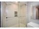 A bathroom features a shower-tub with a glass door enclosure and sleek, modern fixtures at 1564 Pedro Sw Dr, Mableton, GA 30126