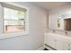 Modern bathroom with double sink vanity, large mirror, and a view to an outdoor deck at 1564 Pedro Sw Dr, Mableton, GA 30126