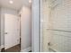 The recently renovated bathroom features modern tile in the shower and a glass door at 1564 Pedro Sw Dr, Mableton, GA 30126