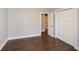 A clean bedroom with hardwood floors, an open doorway, and double door closet provides a move-in ready space at 1564 Pedro Sw Dr, Mableton, GA 30126