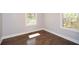 An empty bedroom has hardwood floors and two windows that offer natural light, creating an inviting space at 1564 Pedro Sw Dr, Mableton, GA 30126