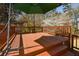 Spacious wooden deck features a green umbrella, creating a relaxing outdoor space at 1564 Pedro Sw Dr, Mableton, GA 30126
