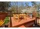 A wooden deck with an outdoor dining table set and a stainless steel grill at 1564 Pedro Sw Dr, Mableton, GA 30126