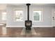 Cozy living room with hardwood floors and wood burning stove at 1564 Pedro Sw Dr, Mableton, GA 30126
