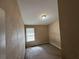 Small bedroom with carpet, window and simple ceiling light at 2863 Windsor Forrest Ct, Atlanta, GA 30349