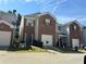 Charming townhome with brick accents, a single-car garage, and a well-maintained front lawn at 2863 Windsor Forrest Ct, Atlanta, GA 30349