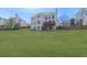 Spacious backyard featuring a well-maintained lawn and a two-story home with a deck at 3891 Greensward Nw Vw, Kennesaw, GA 30144
