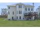 Spacious backyard featuring a well-kept lawn and a two-story home with a wooden deck at 3891 Greensward Nw Vw, Kennesaw, GA 30144