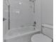 This bathroom features a white tiled shower over tub with updated fixtures and a pristine white toilet at 3891 Greensward Nw Vw, Kennesaw, GA 30144