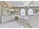 Bright bathroom features a large soaking tub beneath a beautiful arched window at 3891 Greensward Nw Vw, Kennesaw, GA 30144