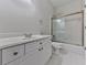 Bathroom with white cabinets, sink, and shower with glass doors at 3891 Greensward Nw Vw, Kennesaw, GA 30144