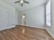 Bedroom with hardwood flooring, with view to bath, and a large window at 3891 Greensward Nw Vw, Kennesaw, GA 30144
