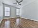Spacious bedroom featuring hardwood floors, neutral walls, and two windows for natural light at 3891 Greensward Nw Vw, Kennesaw, GA 30144