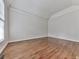Bright bedroom with hardwood floors, vaulted ceilings, neutral paint, and large window for natural light and ventilation at 3891 Greensward Nw Vw, Kennesaw, GA 30144