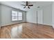 Light-filled bedroom showcases hardwood floors and a large window, creating a cozy and inviting space at 3891 Greensward Nw Vw, Kennesaw, GA 30144
