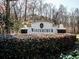 The 'Winterthur' community sign amidst meticulously manicured landscaping, showcasing a welcoming neighborhood entrance at 3891 Greensward Nw Vw, Kennesaw, GA 30144