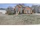 Traditional brick home with manicured lawn, mature trees, attractive landscaping, and inviting entryway at 3891 Greensward Nw Vw, Kennesaw, GA 30144