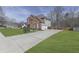 Well-maintained home features a brick facade, three-car garage, beautiful landscaping, and a curved driveway at 3891 Greensward Nw Vw, Kennesaw, GA 30144