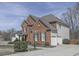 Well-maintained home boasts brick facade, three-car garage, beautiful landscaping, and a curved driveway at 3891 Greensward Nw Vw, Kennesaw, GA 30144