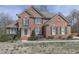 Traditional brick home with manicured lawn, mature trees, attractive landscaping, and inviting entryway at 3891 Greensward Nw Vw, Kennesaw, GA 30144