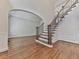 Open foyer features hardwood floors, staircase with wood and iron railing, and arched doorway leading to the rest of the home at 3891 Greensward Nw Vw, Kennesaw, GA 30144
