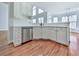 Modern kitchen featuring white cabinets, stainless steel dishwasher, and ample counter space at 3891 Greensward Nw Vw, Kennesaw, GA 30144