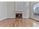 Bright living room featuring a fireplace, beautiful hardwood floors, and large windows at 3891 Greensward Nw Vw, Kennesaw, GA 30144