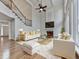 Cozy living room with a fireplace, white sofas, and lots of natural light at 3891 Greensward Nw Vw, Kennesaw, GA 30144