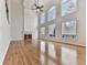 Open living room features hardwood floors, fireplace, cathedral ceilings, and floor-to-ceiling windows for natural light at 3891 Greensward Nw Vw, Kennesaw, GA 30144