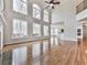 Bright living room boasts soaring ceilings, large windows, and gleaming hardwood floors, perfect for entertaining at 3891 Greensward Nw Vw, Kennesaw, GA 30144