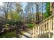 Lush backyard garden with retaining wall, grass and shrubbery at 4370 Landover Way, Suwanee, GA 30024