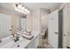 Bathroom with double vanity sink, granite countertops, tiled floor, and a view of the toilet and shower at 4370 Landover Way, Suwanee, GA 30024