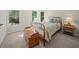 Cozy bedroom with iron bed frame, chest of drawers, carpet flooring, and natural light at 4370 Landover Way, Suwanee, GA 30024