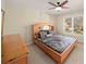 Comfortable bedroom with neutral tones, carpet flooring, and large window overlooking the neighborhood at 4370 Landover Way, Suwanee, GA 30024