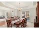 Formal dining room with elegant chandelier and a large table for eight at 4370 Landover Way, Suwanee, GA 30024