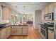 Spacious kitchen with stainless steel appliances, dark countertops, and hardwood floors at 4370 Landover Way, Suwanee, GA 30024