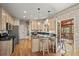 Well-lit kitchen with stainless steel appliances, center island, breakfast bar, and access to a screened deck at 4370 Landover Way, Suwanee, GA 30024