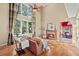Bright living room with hardwood floors, fireplace, and a large window at 4370 Landover Way, Suwanee, GA 30024