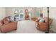Cozy living room with comfortable seating, a large window and neutral-colored carpet at 4370 Landover Way, Suwanee, GA 30024
