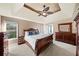 Comfortable main bedroom with decorative ceiling fan, warm colors, carpet, and large furniture at 4370 Landover Way, Suwanee, GA 30024