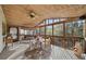 Inviting screened porch with wood ceiling, ceiling fan, porch swing and comfortable seating with a view of wooded yard at 4370 Landover Way, Suwanee, GA 30024