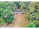 Overhead view of home nestled among mature trees and large grassy yard at 105 Simonton (Tract 1) Se Rd, Lawrenceville, GA 30046